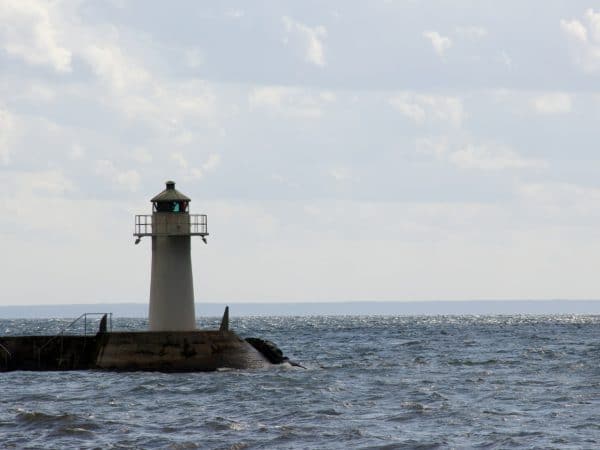 Ein Leuchtturm und um ihn herum See und Wolken